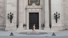 A woman walks past the entrance of Freemasons' Hall in London 