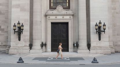 A woman walks past the entrance of Freemasons' Hall in London 