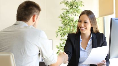 Two people at a job interview sat at a desk