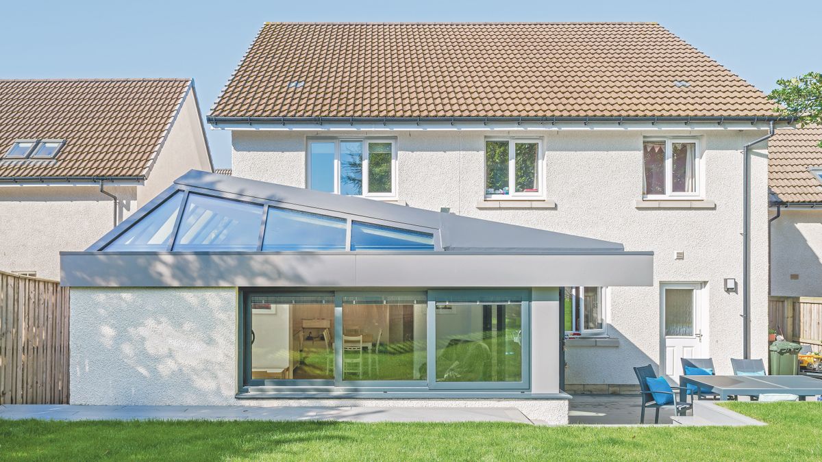 white rendered house with grey roof extension