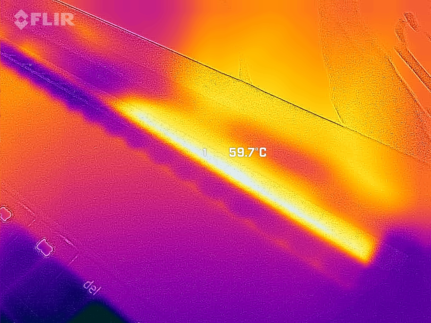 Razer Blade 18 (2025) tested under stress while benchmarking, photographed with a thermal camera.