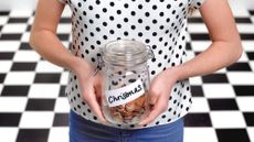 Person holding Christmas savings jar