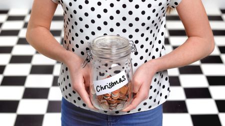 Person holding Christmas savings jar