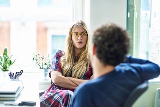 Businesswoman and businessman talking in modern office