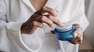 Woman holding face cream