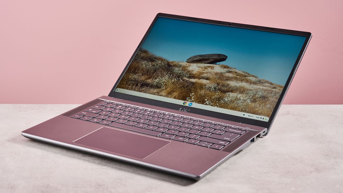 Acer Chromebook Plus 516 open wide on desk with pink background