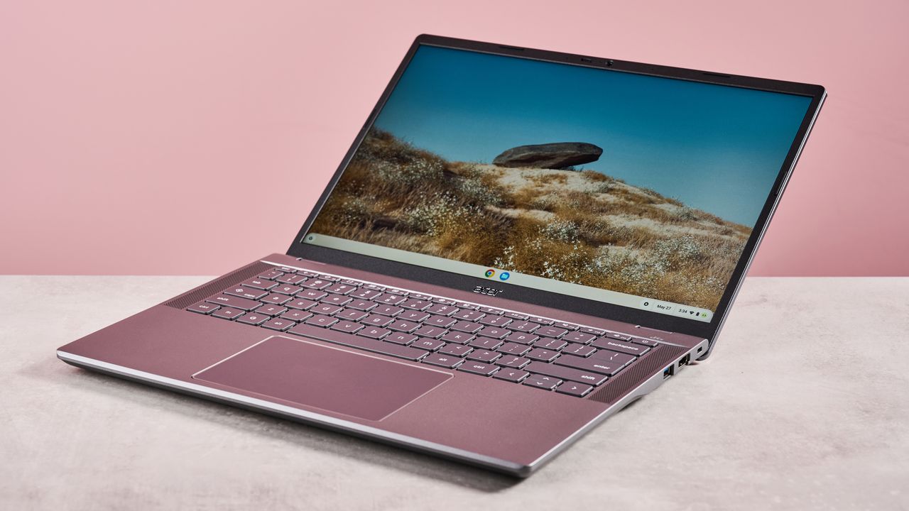 Acer Chromebook Plus 516 open wide on desk with pink background