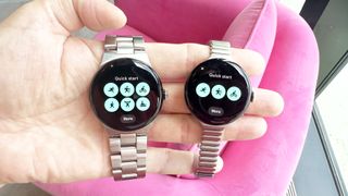 Google Pixel Watch 3 and Pixel Watch 3 XL in a user&#039;s hand against a pink background