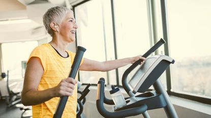 Mature woman on one of the best elliptical machines in gym