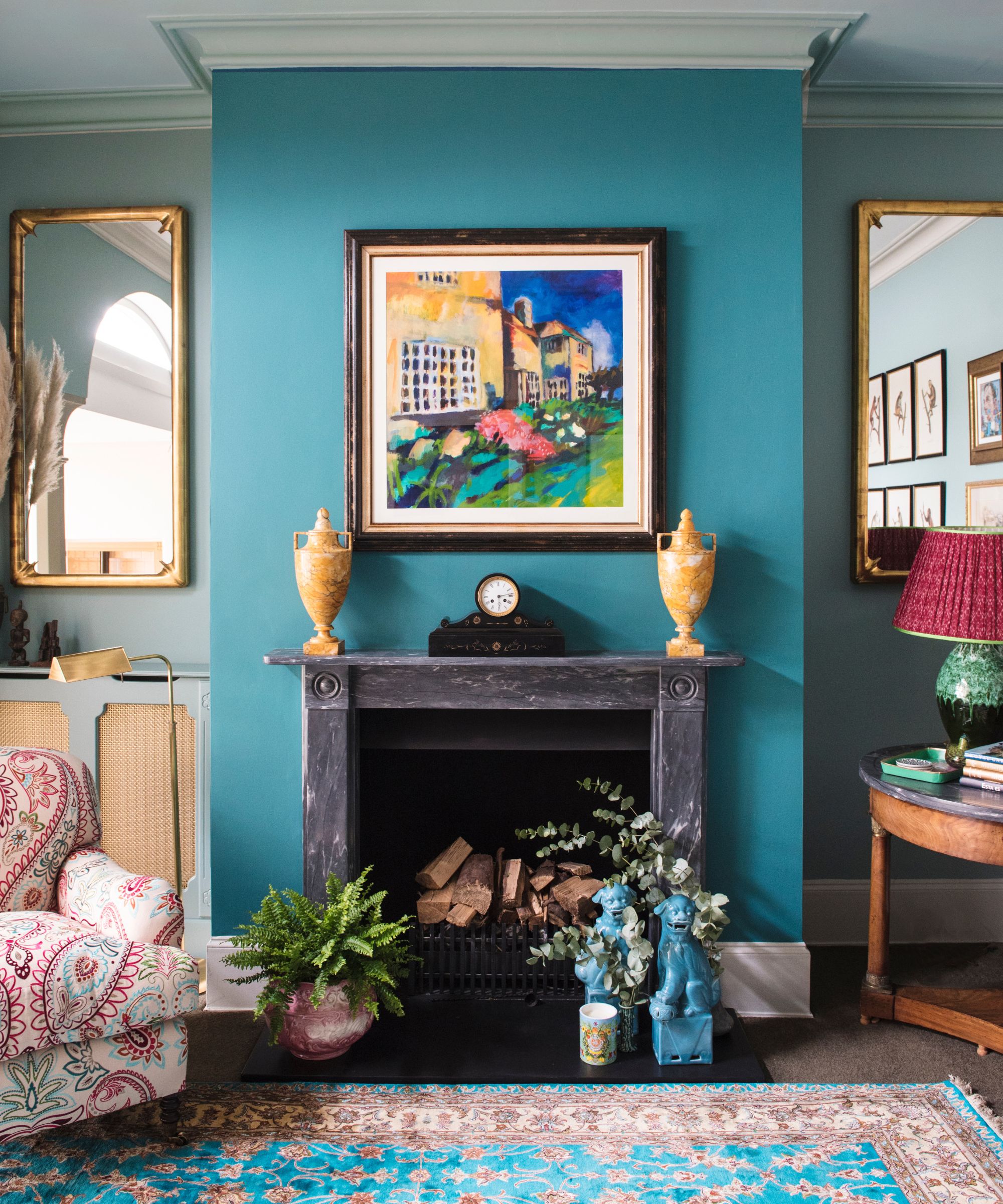 maximalist living room with teal feature wall