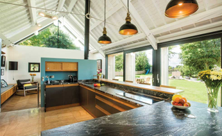 modern barn conversion blue wall kitchen
