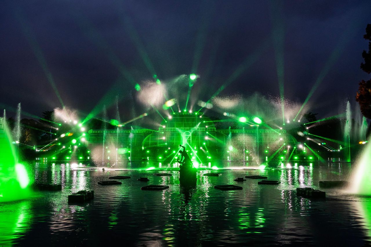 Lights and water jets dazzle over the Palm House pond and glasshouse at RBG Kew. The Christmas Lights trail is open now until January 5.