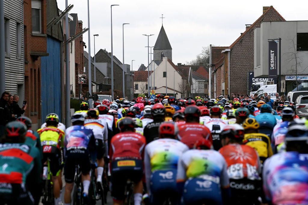 WAREGEM BELGIUM MARCH 29 A general view of the peloton passing through a Ooigem village during the 77th Dwars Door Vlaanderen 2023 Mens Elite a 1837km one day race from Roeselare to Waregem DDV23 on March 29 2023 in Waregem Belgium Photo by Tim de WaeleGetty Images