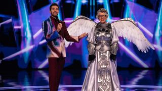 Dame Prue Leith unmasked as Pegasus in The Masked Singer 2025 - standing next to Joel Dommett on stage.