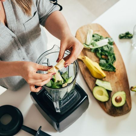 Cambridge diet: A woman chopping some green vegetables