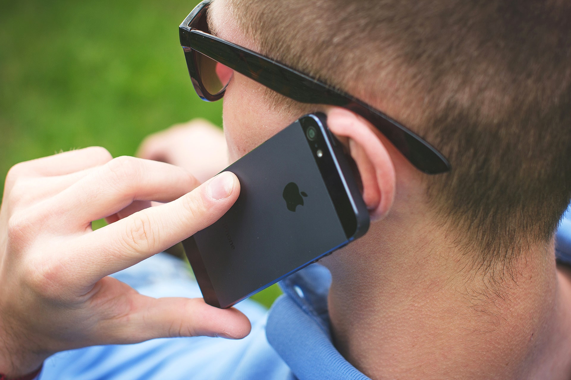 A person making a phone call on an iPhone.