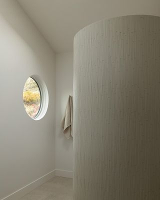 minimalist bathroom with curved shower wall