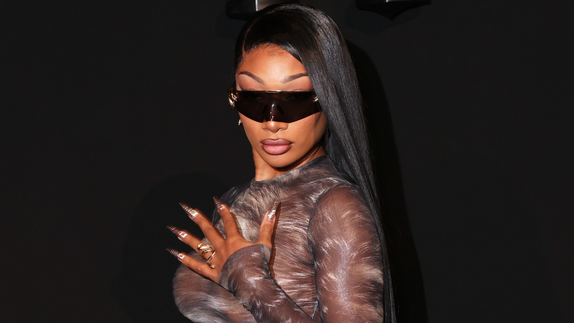 Megan Thee Stallion arrived at the Roberto Cavalli Milan Fashion Week show in a thong-revealing naked dress