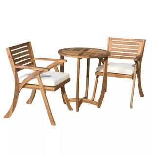 Wooden bistro set with table and chairs with white cushions