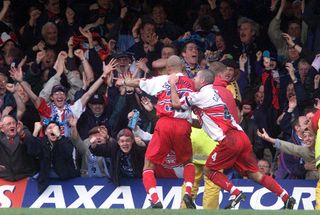 Roy Essandoh celebrates with teammate Jason Cousins after scoring Wycombe Wanderers' winning goal against Leicester City in the FA Cup, 2001