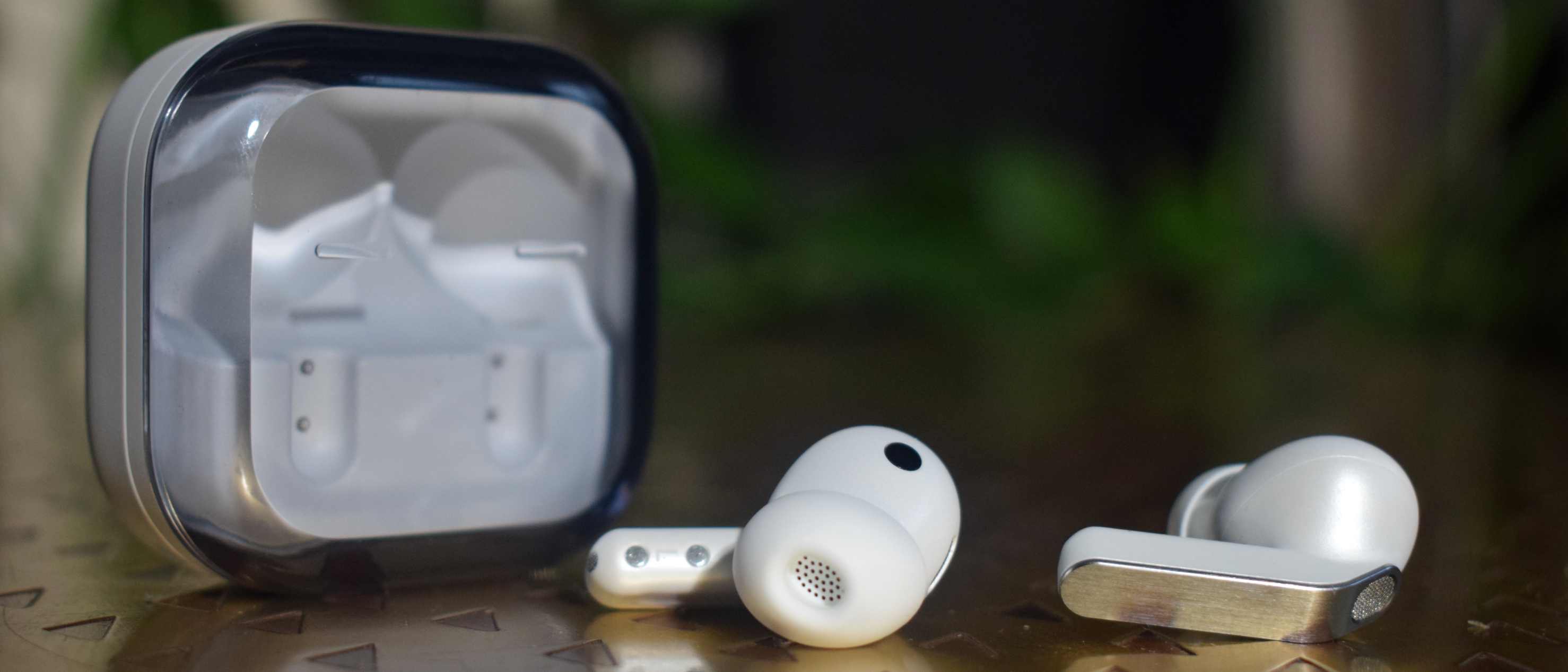 The Samsung Galaxy Buds 4 Pro on a table, next to the case.