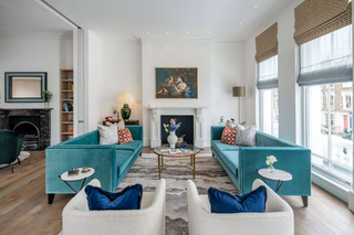 a living room with blue sofas