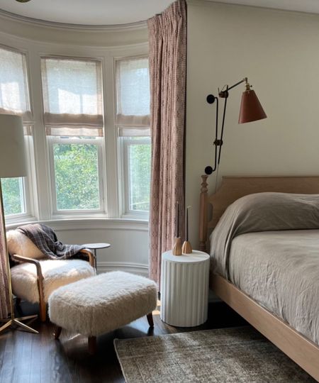 bedroom with bay window and white chair