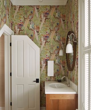 Bathroom with green pheasant wallpaper and a wooden vanity unit