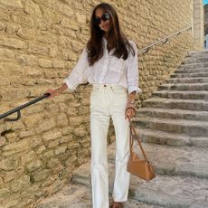 A fashion girl in a white linen top and white jeans