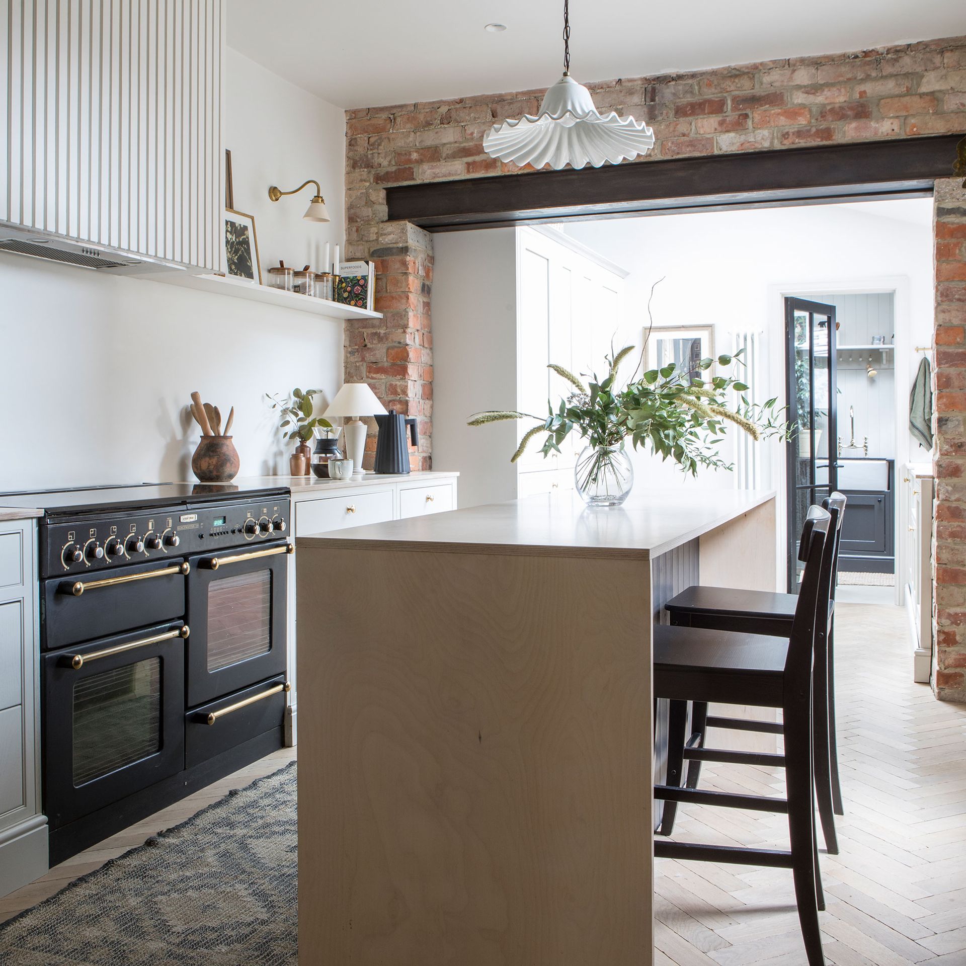 Neutral kitchen with brick door surround