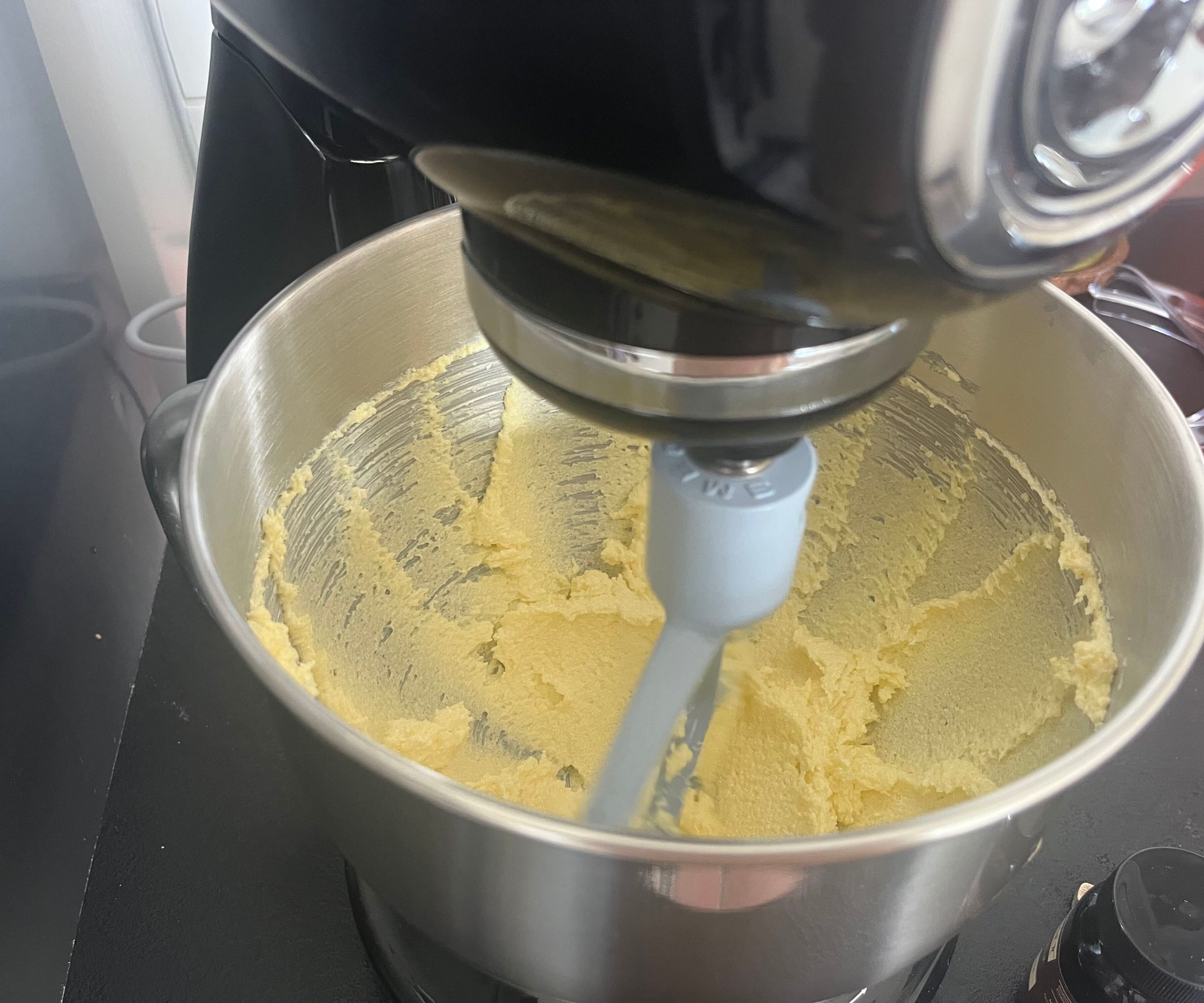 Vanilla cake batter being mixed in the black SMEG Forte Stand Mixer