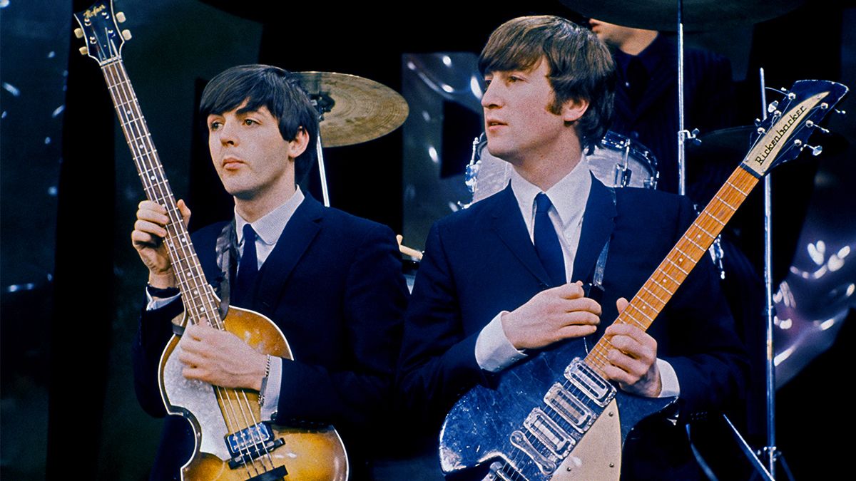 British Rock musicians Paul McCartney (left) and John Lennon (1940 - 1980), of the group the Beatles, perform on the set of &#039;The Ed Sullivan Show&#039; at CBS&#039;s Studio 50, New York, New York, February 8, 1964. The photo was taken during rehearsals for the group&#039;s debut performance on the show the following day. Note that the backdrop was very different from the one used in the broadcast. 