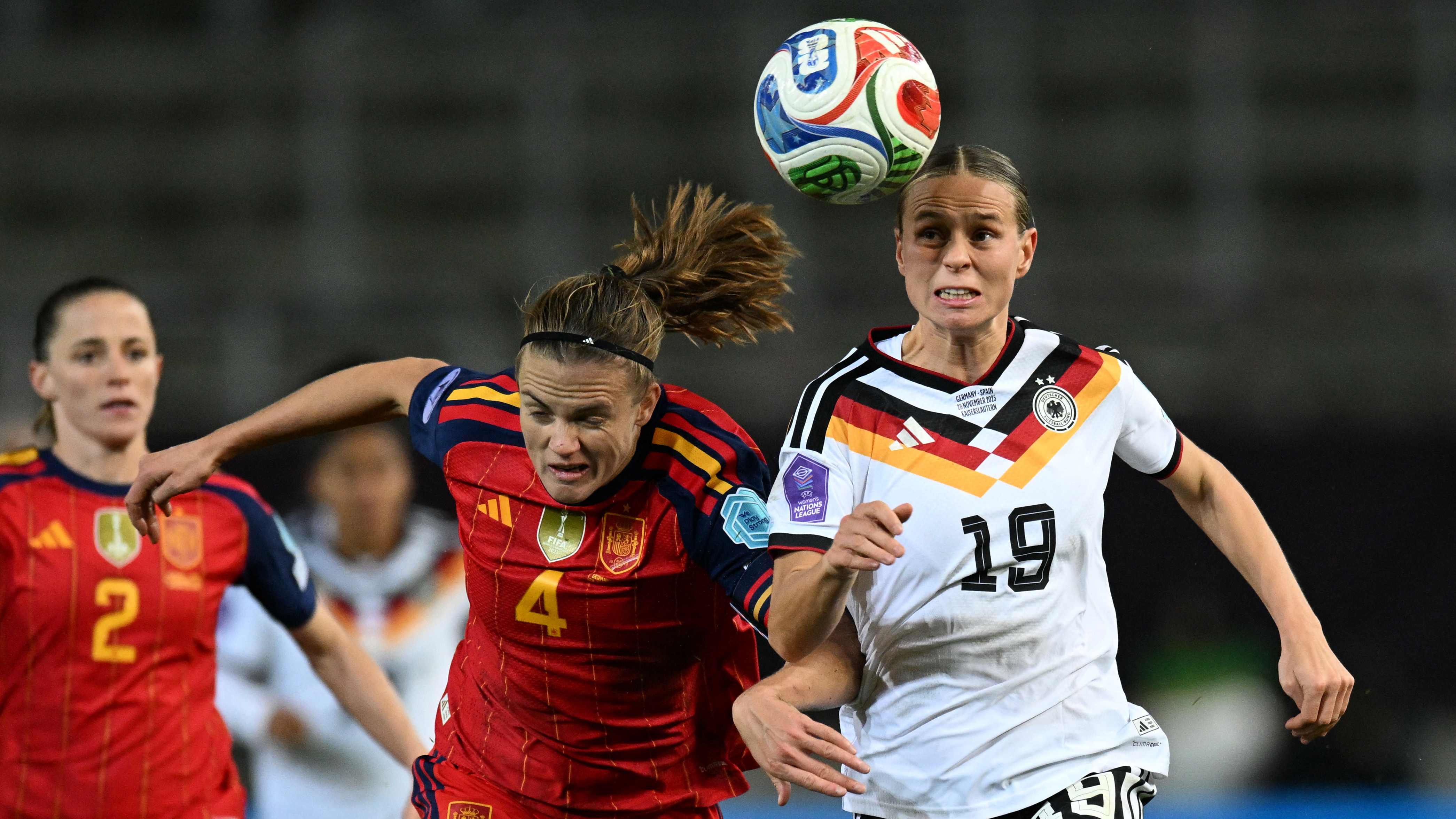 Germany's midfielder #19 Klara Buehl (R) and Spain's defender #04 Irene Paredes vie for the ball during UEFA Women's Nations League first leg final football match between Germany and Spain in Kaiserslautern, western Germany on November 28, 2025.