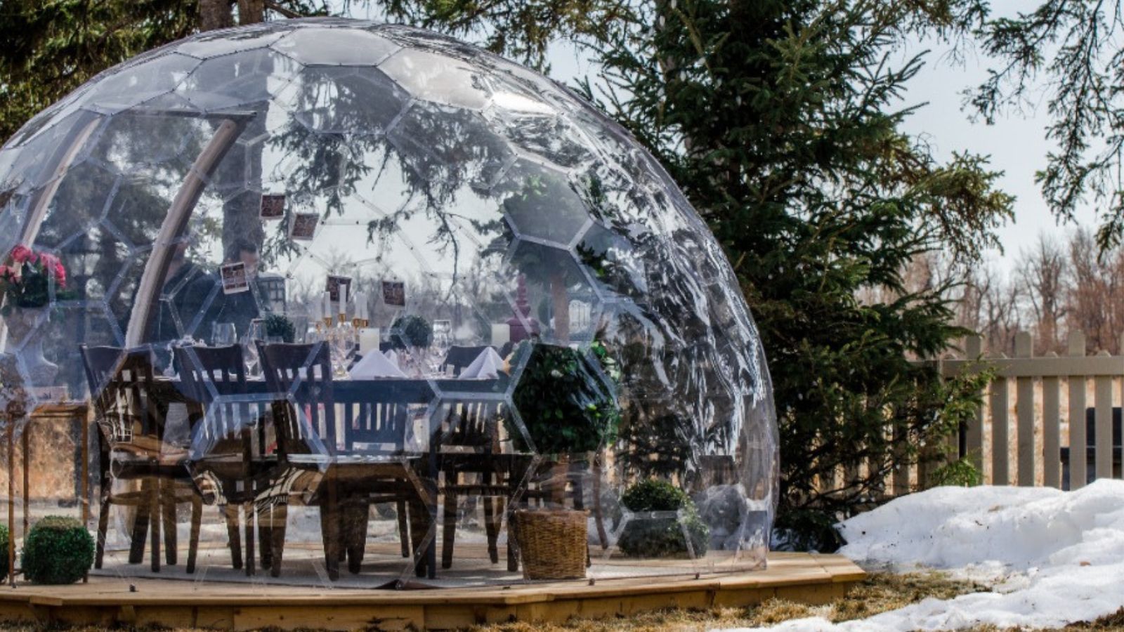 Bubble dome kitted out with dining set in a snowy garden