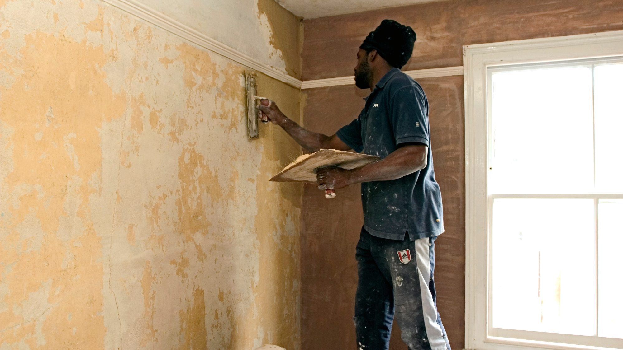 man skimming walls