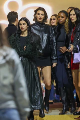 kendall jenner wears a leather bomber jacket with a mini skirt and leather boots at the sabrina carpenter concert on november 17