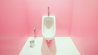 Urinal in a pink room