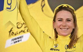 Annemiek van Vleuten celebrates her overall victory in the yellow jersey at the end of the Tour de France Femmes