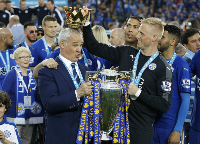 Kasper Schmeichel places the Premier League crown on Claudio Ranieri's head