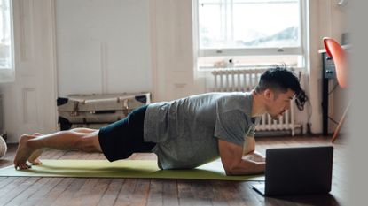 Man doing the plank as part of a home workout