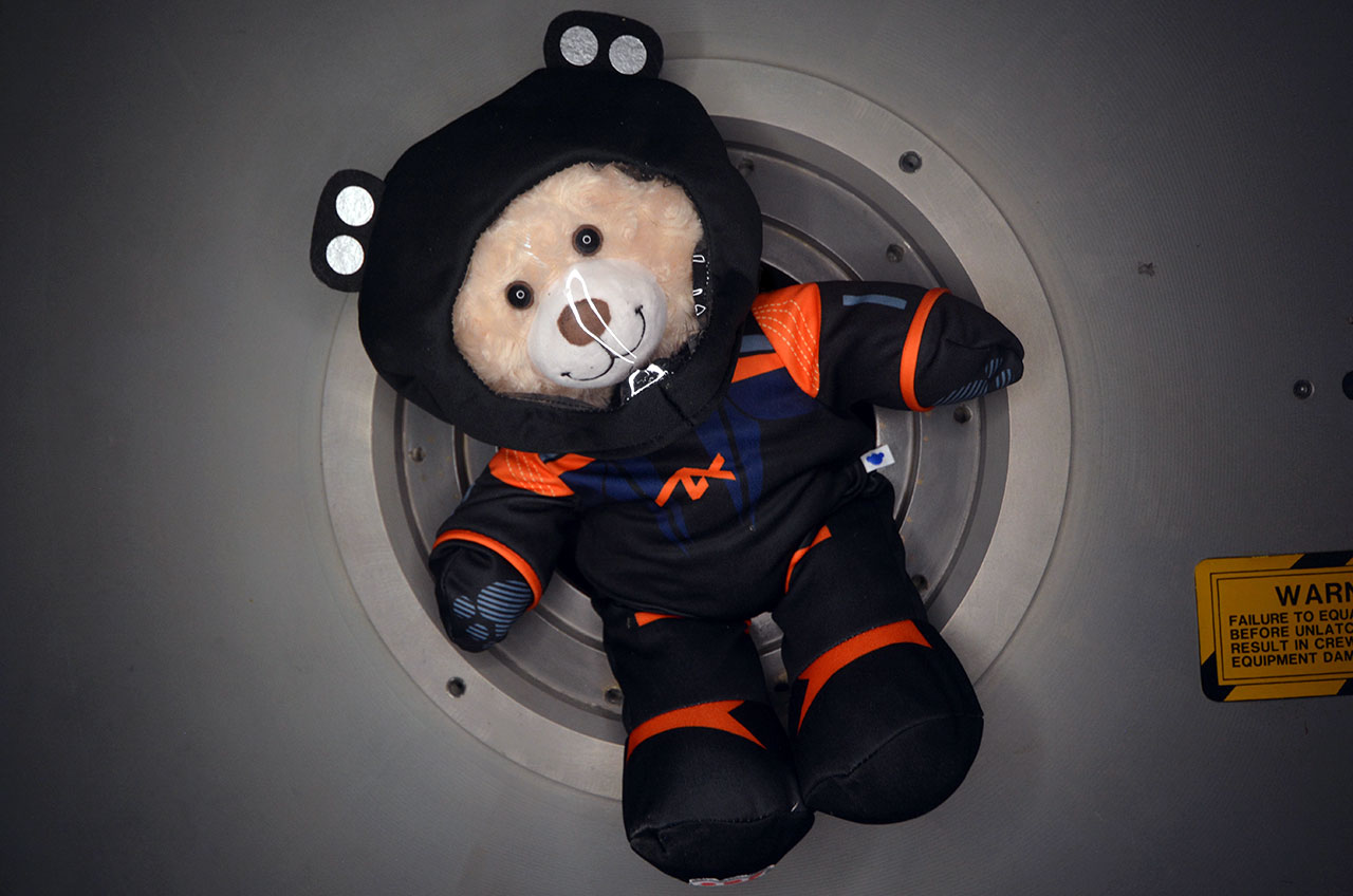 The Axiom Space Bear, a larger version of the Ax-2 zero-g indicator "GiGi," features Build-A-Bear's "Happy Hugs Teddy" wearing Axiom Space's AxEMU spacesuit.