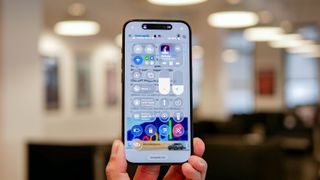 iOS 26 developer beta running on iPhone showing Liquid Glass interface.