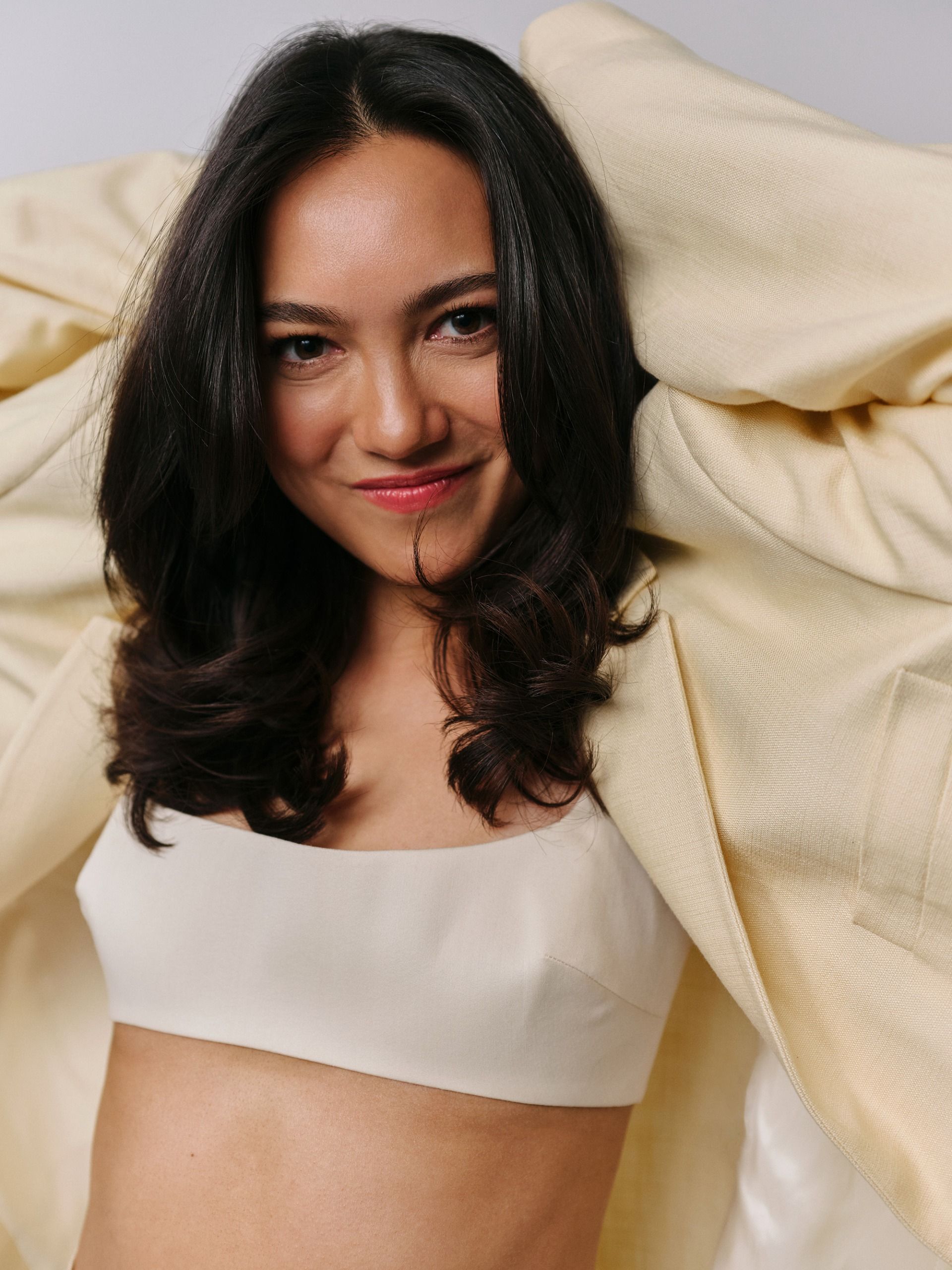 Rachel Marsh wearing a butter yellow suit with a white bralette.