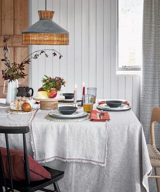 Fall table decor ideas with layered grey linen and natural wood accessories