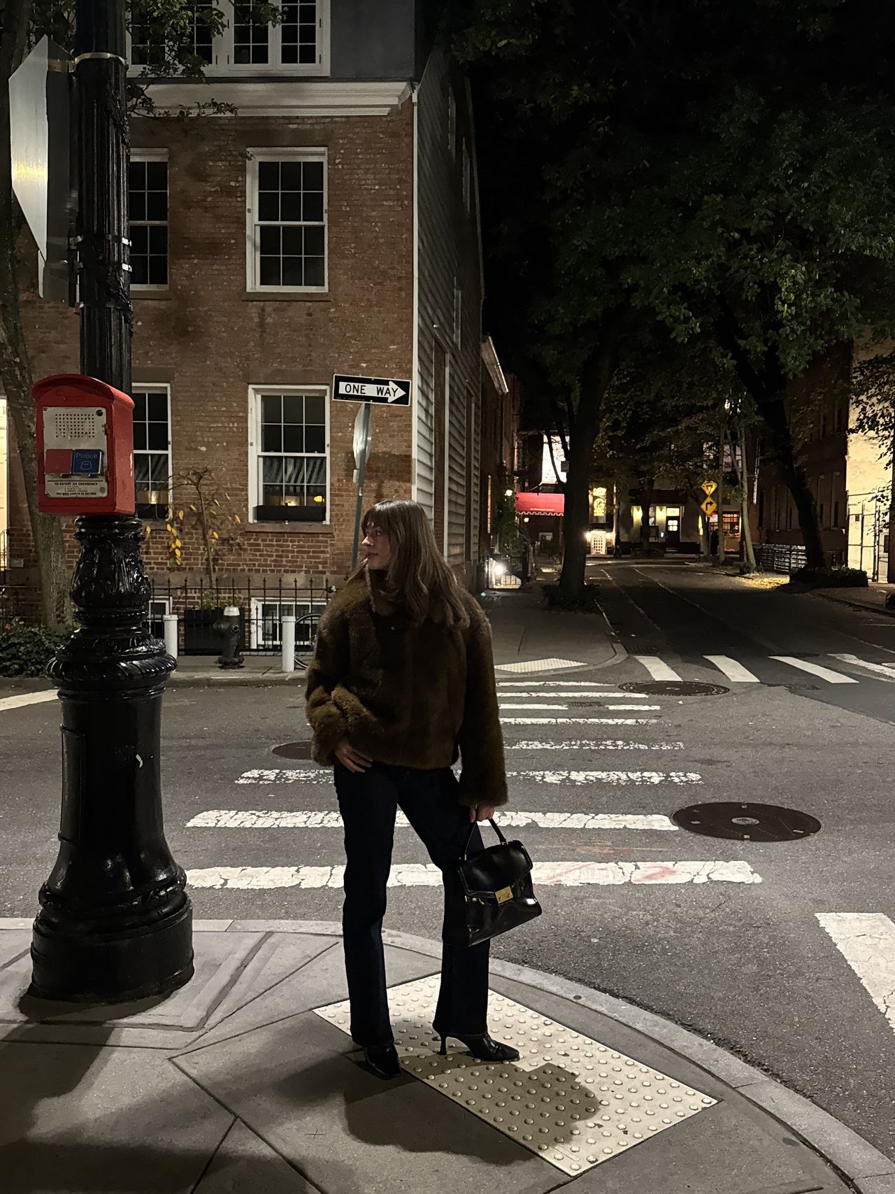 Kathryn Zahorak wearing fur jacket, black handbag, jeans on new york city street