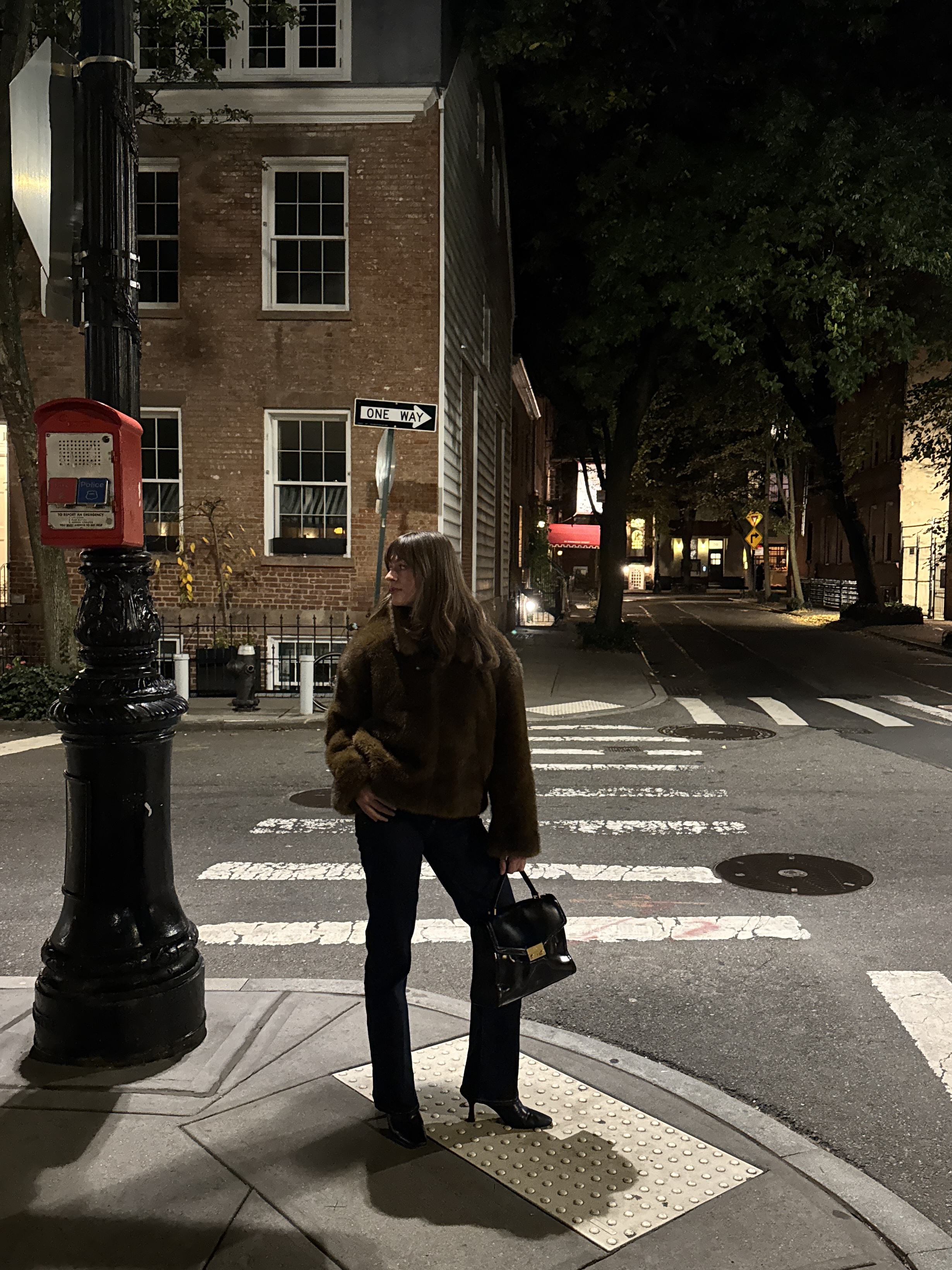 Kathryn Zahorak wearing fur jacket, black handbag, jeans on new york city street 