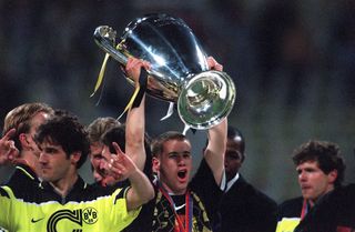 Lars Ricken lifts the Champions League trophy after Borussia Dortmund's win over Juventus in the 1997 final.