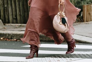 Woman in burgundy boots and boho dress