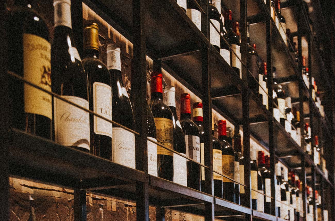 Rows on wine bottles on a shelf