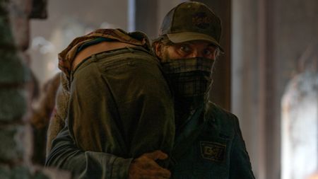 Cillian Murphy holding a boy in A Quiet Place Part II.